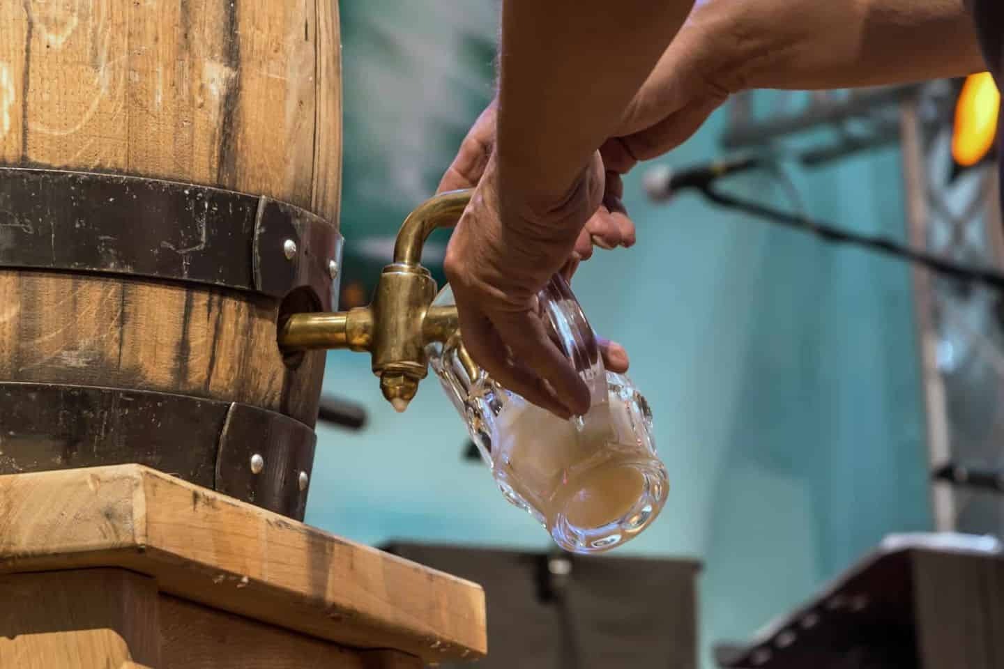 Fresh Craft Beer Poured from a Wooden Barrel