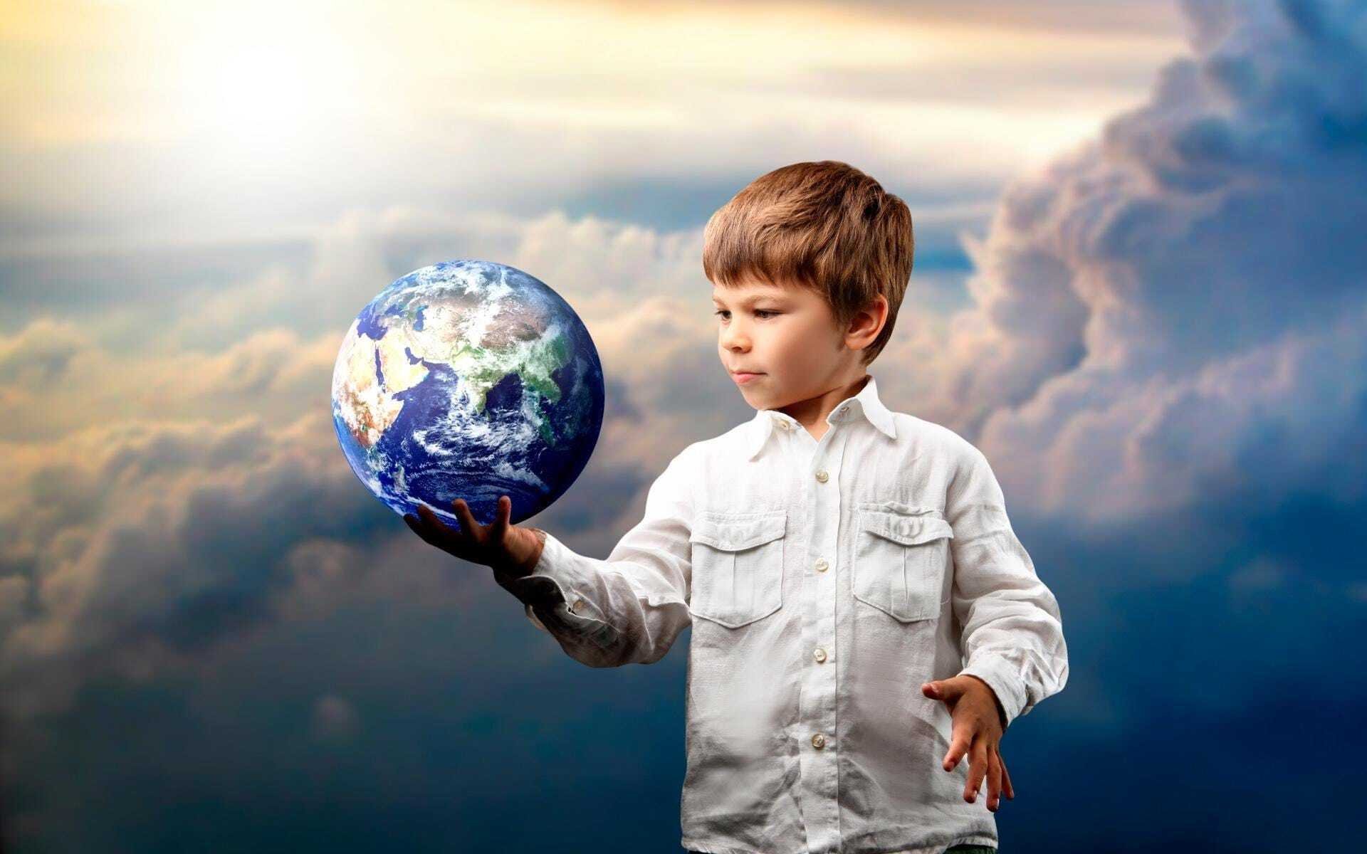 Photography of a kid holding a globe