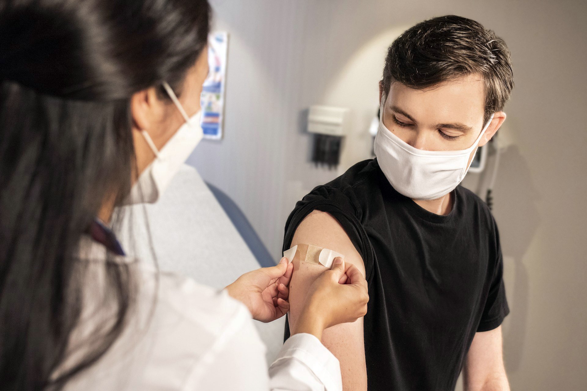 A nurse applying a band-aid